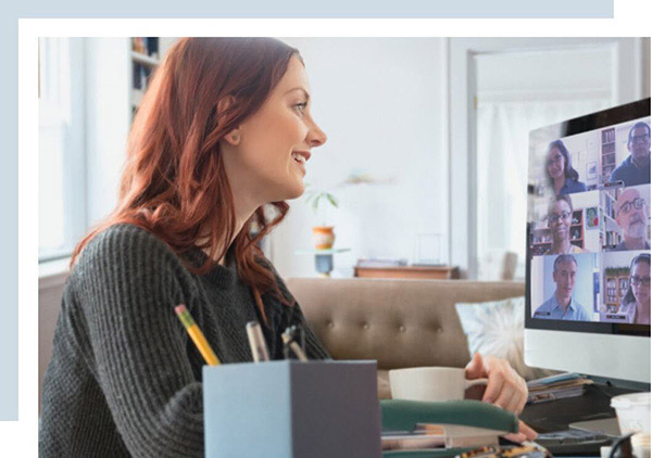 a woman student on a computer and on a video call with other students