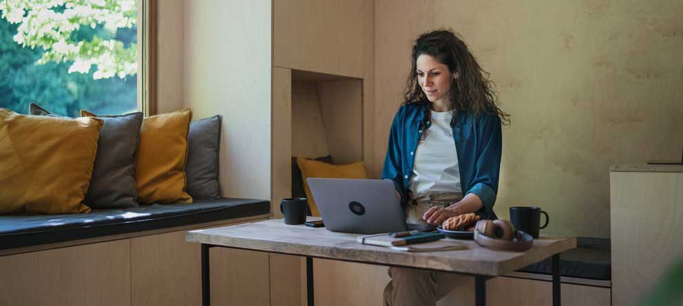 Working student catching up on online master's courses while traveling