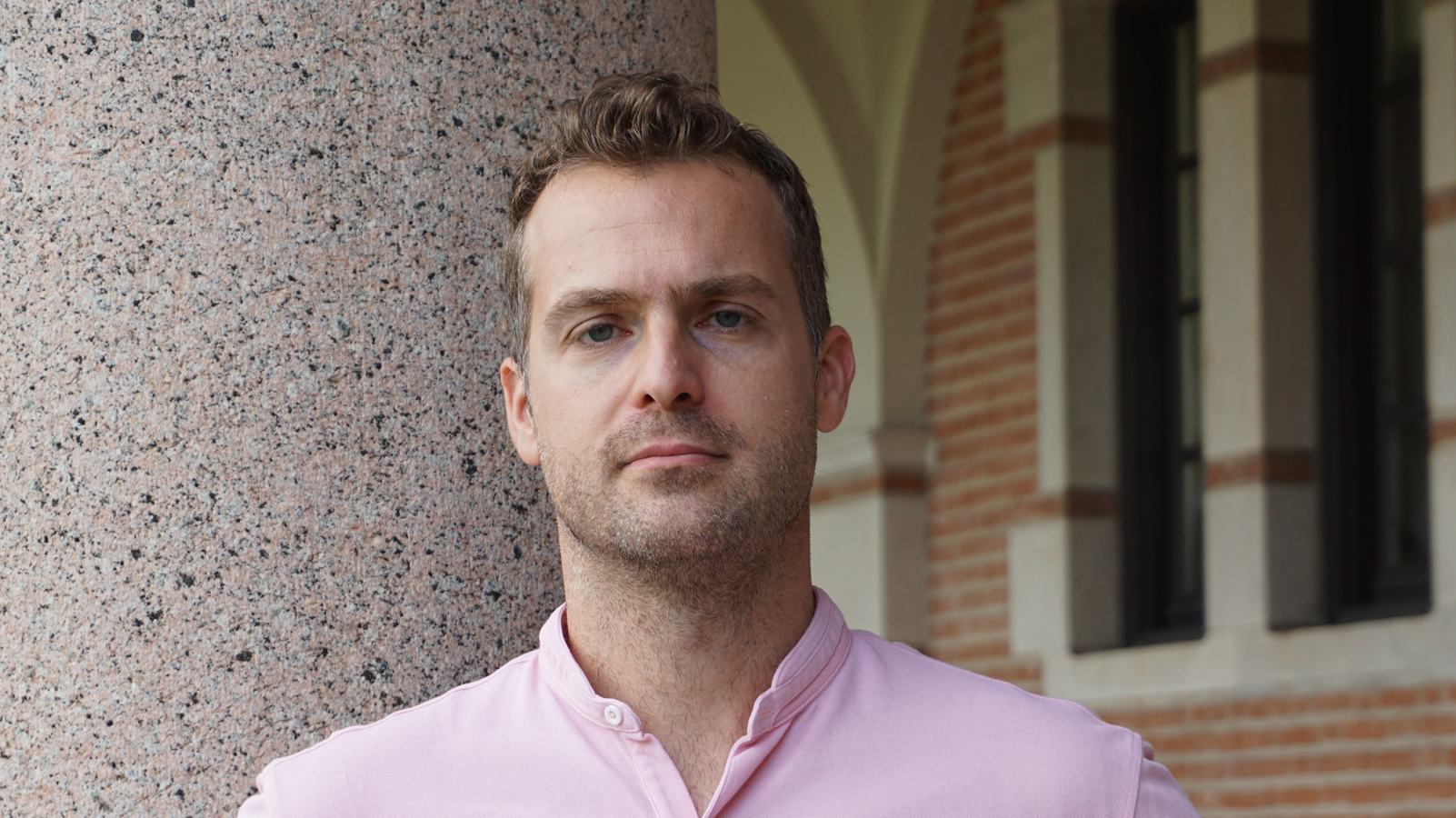 Anastasios Kyrillidis stands outside on the Rice University campus