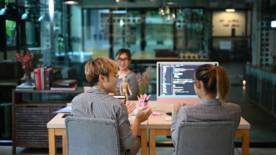 Two Master of Computer Science students brainstorming a solution to a problem. Two Master of Computer Science students brainstorming a solution to a problem.