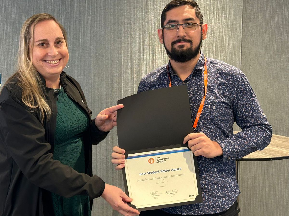 Woman presents ICRC Best Poster Award certificate to Rice CS PhD student David Quiroga