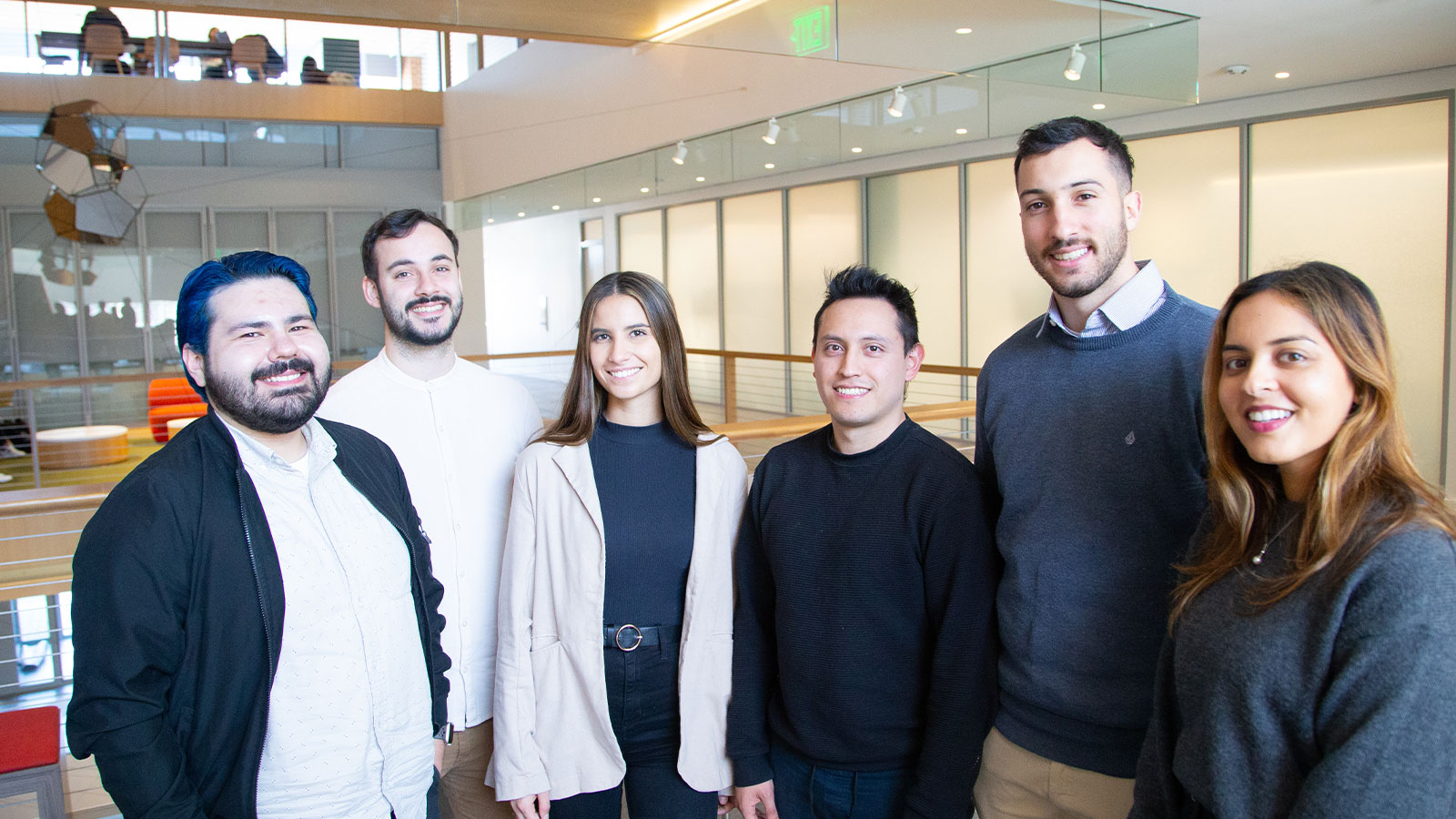 EPMP Fulbright students stand in an atrium at Rice University 