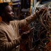 a man in the server room fixing the wires 